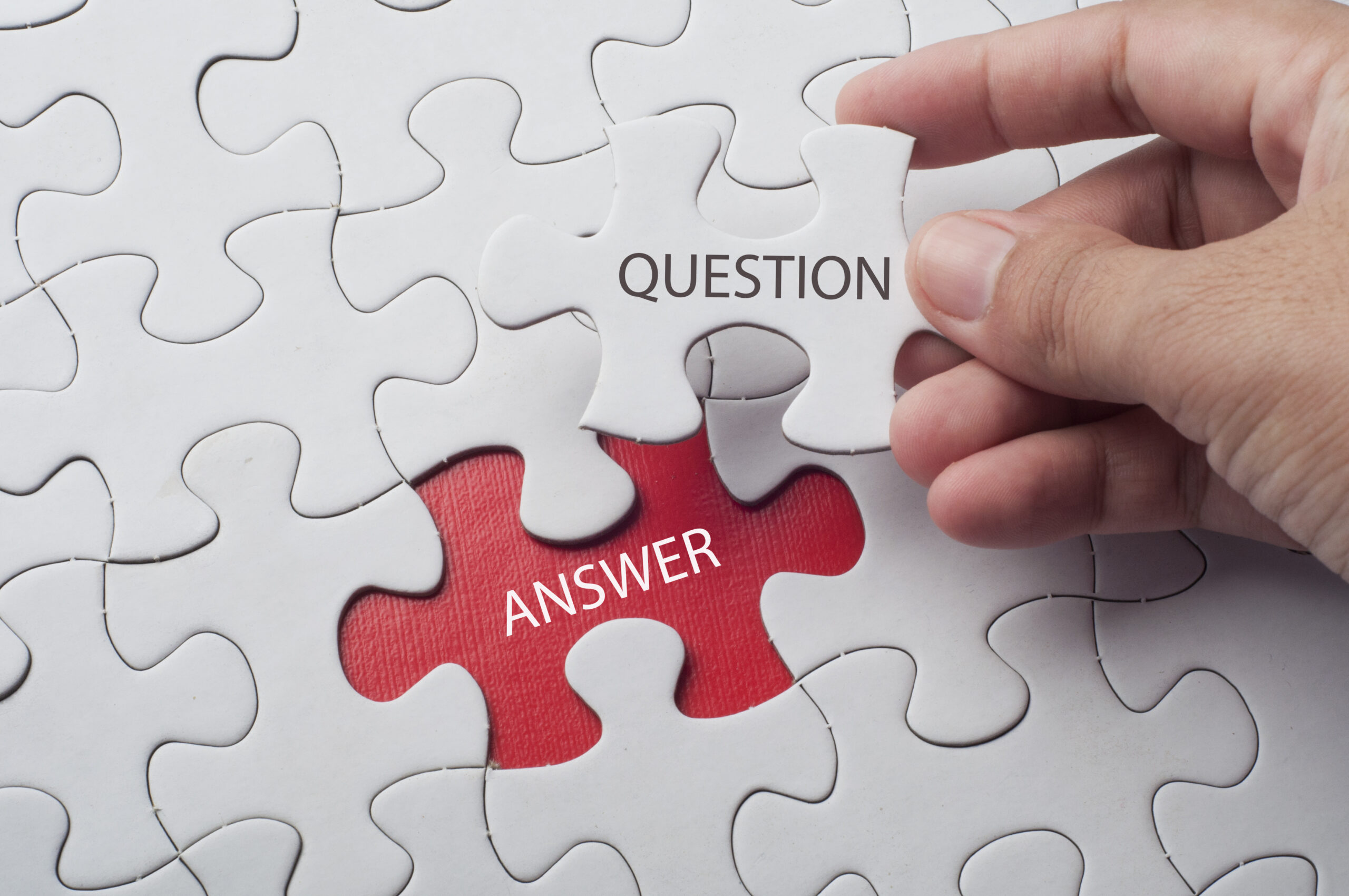 Hand,Holding,Piece,Of,Jigsaw,Puzzle,With,Word,Question,&amp;